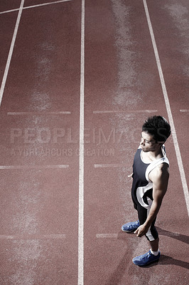 Buy stock photo Thinking, runner or top view of man on track for training, outdoor workout or sports exercise. Night, fitness and confident athlete waiting in stadium for running development or race performance