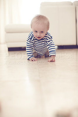 Buy stock photo A cute baby boy crawling on the floor at home