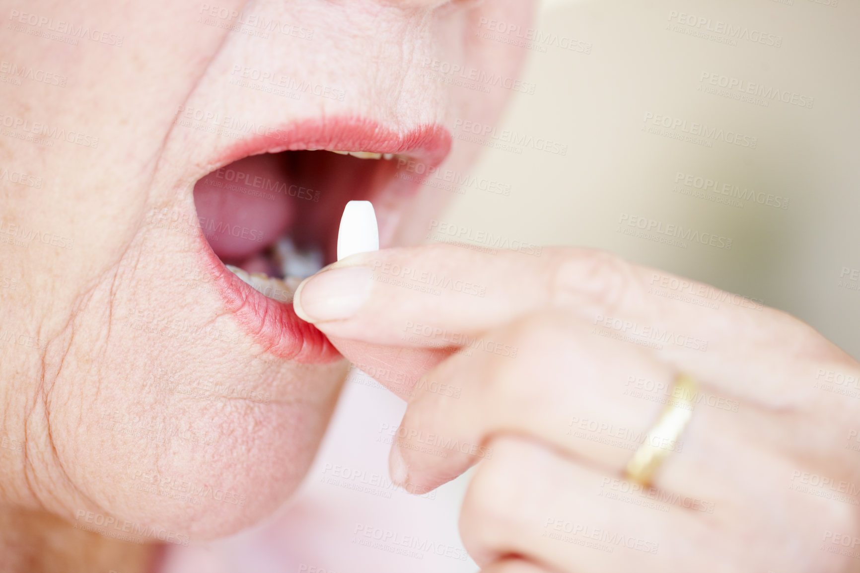 Buy stock photo Closeup of one elderly woman putting pill tablet into her mouth. Senior female taking health supplement treatment 	and prescribed dosage of antibiotic and painkiller medicine to cure and heal symptoms