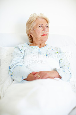 Buy stock photo Ailing senior woman looks away as she contemplates her illness - Copyspace