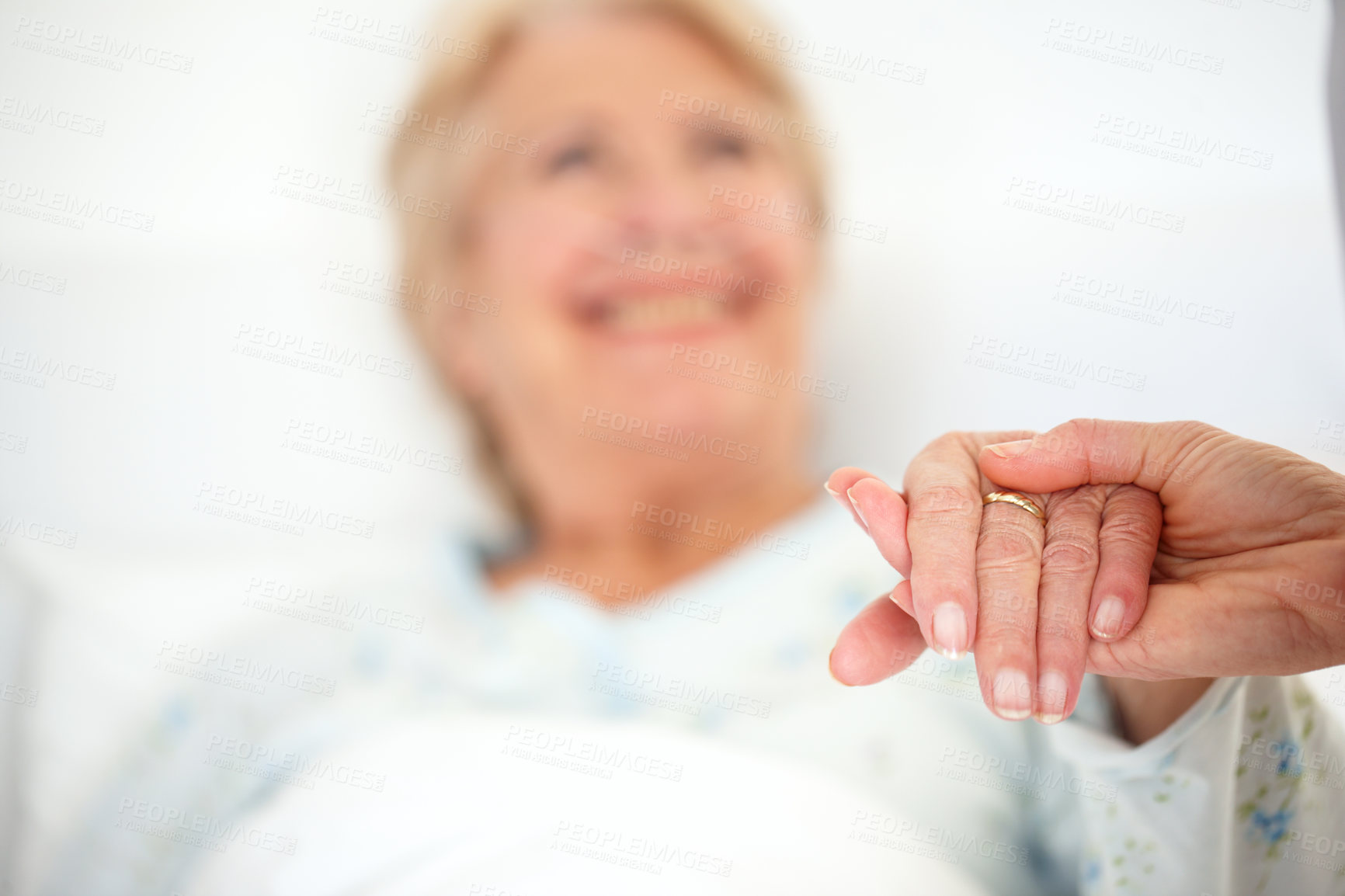 Buy stock photo Closeup of an elderly patient's hand being held by a visitor - Focus on foreground