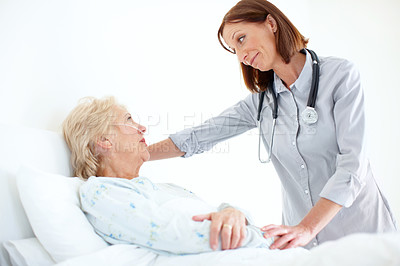 Buy stock photo Mature doctor pays her elderly female patient a visit following an operation