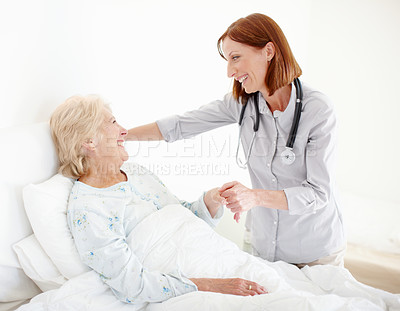 Buy stock photo Mature doctor pays her elderly female patient a visit following an operation