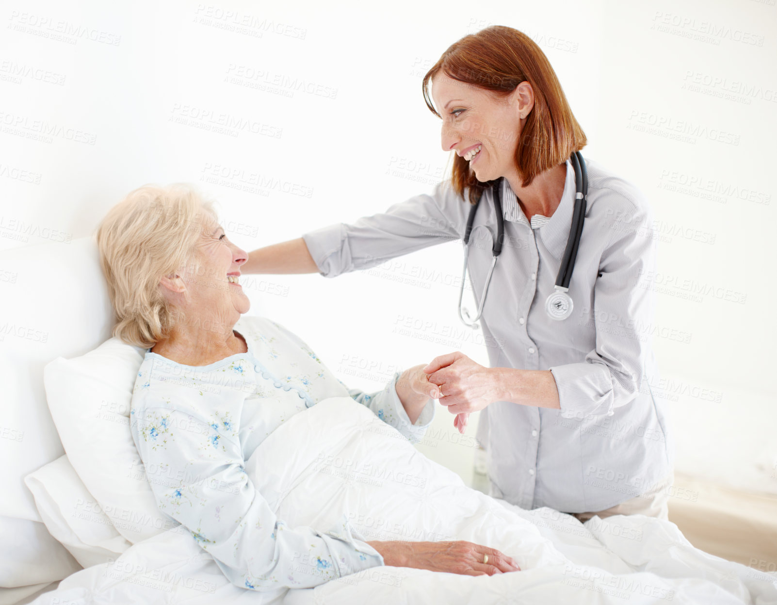 Buy stock photo Mature doctor pays her elderly female patient a visit following an operation