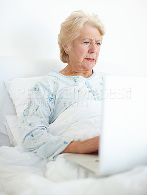 Buy stock photo Hospital, old woman and laptop for illness, patient and research of disease, healthcare and medicine. Tech, typing and senior person with app, online and info of treatment for dementia and knowledge