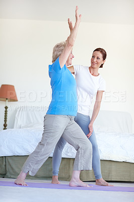 Buy stock photo Trainer, house and senior woman with stretching, fitness and help with guidance, wellness and care. Apartment, bedroom and pensioner with instructor, retirement and activity with healthy and routine