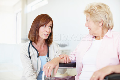 Buy stock photo Woman, doctor and senior patient with wheelchair for elderly care, consultation or medical aid at hospital. Healthcare, worker or employee talking to person with a disability for advice or therapy