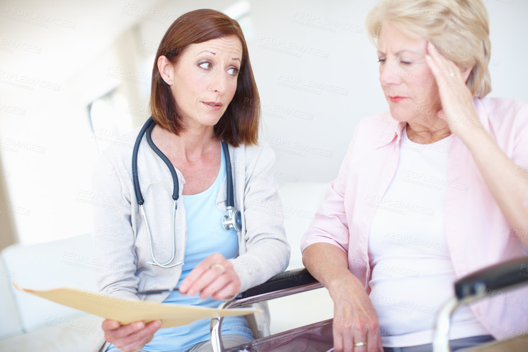 Buy stock photo Elderly patient receives some disturbing news from her nurse