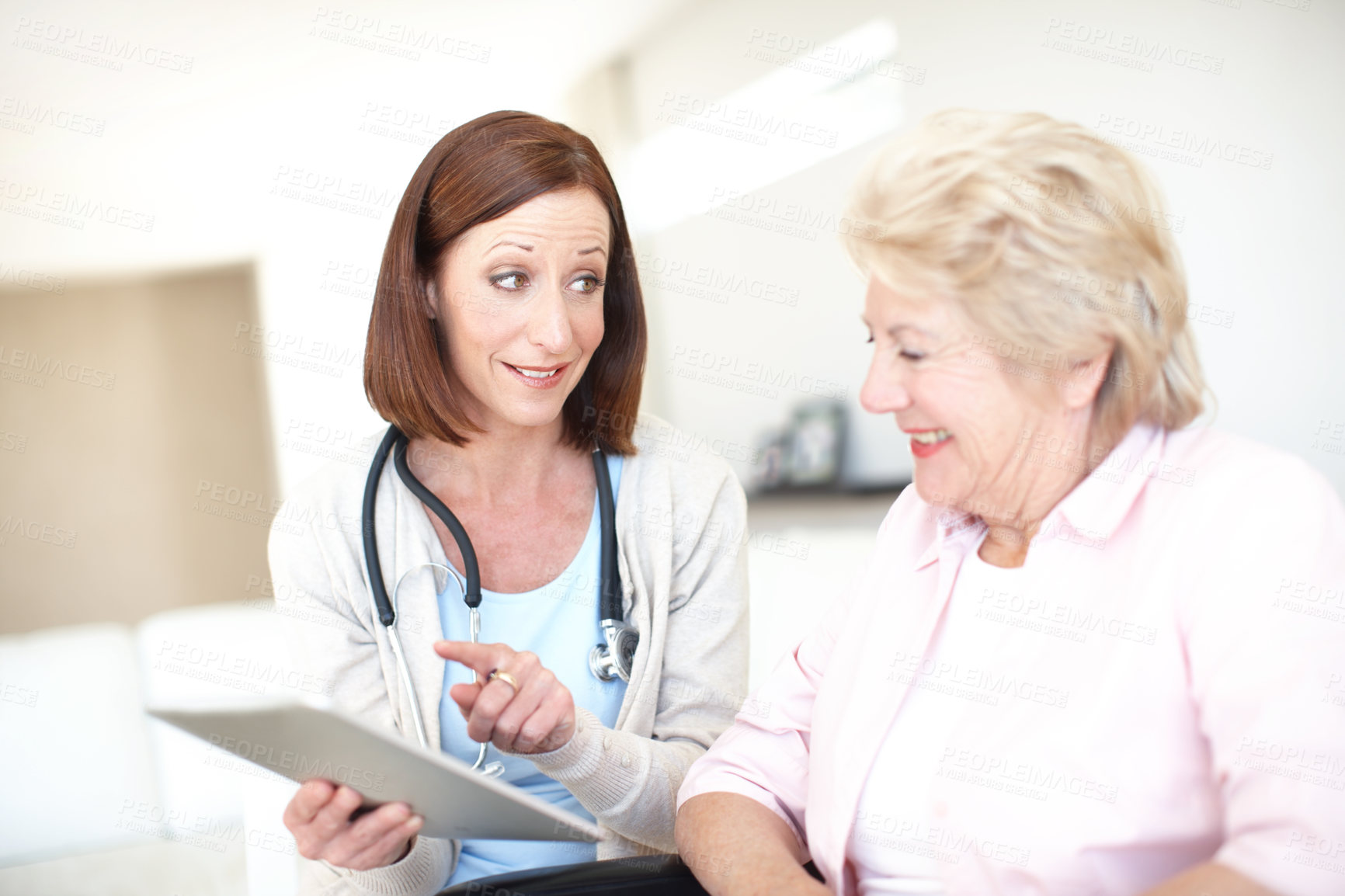 Buy stock photo Happy women, patient or doctor with tablet for elderly care, consultation or health advice at clinic. Female people, healthcare worker or employee talking to senior person on technology for good news