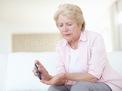 Buy stock photo Woman, home and senior patient with diabetes for injection, sick or pen on finger in elderly care. Mature person,  pensioner or medical tool with diabetic needle prick, illness and chronic disease