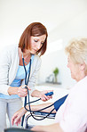 Checking that her blood pressure is normal - Senior Health