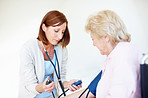 Getting the readings on her patient's blood pressure