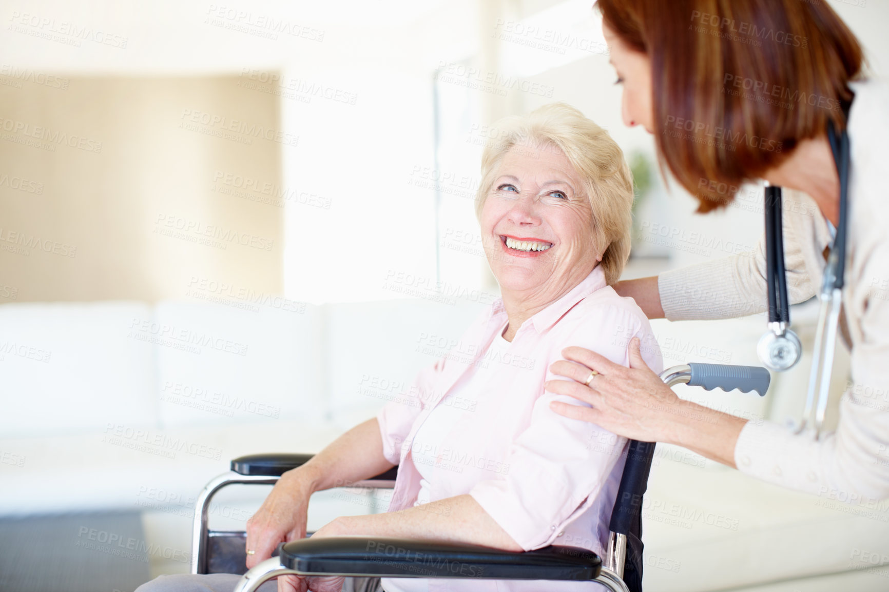 Buy stock photo Mature nurse greets her wheelchair-bound senior patient from behind - Copyspace