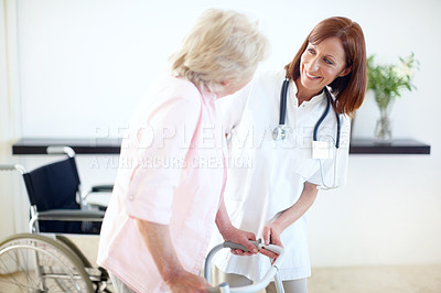 Buy stock photo Nurse and elderly patient look at one another while she assists her with a zimmer frame