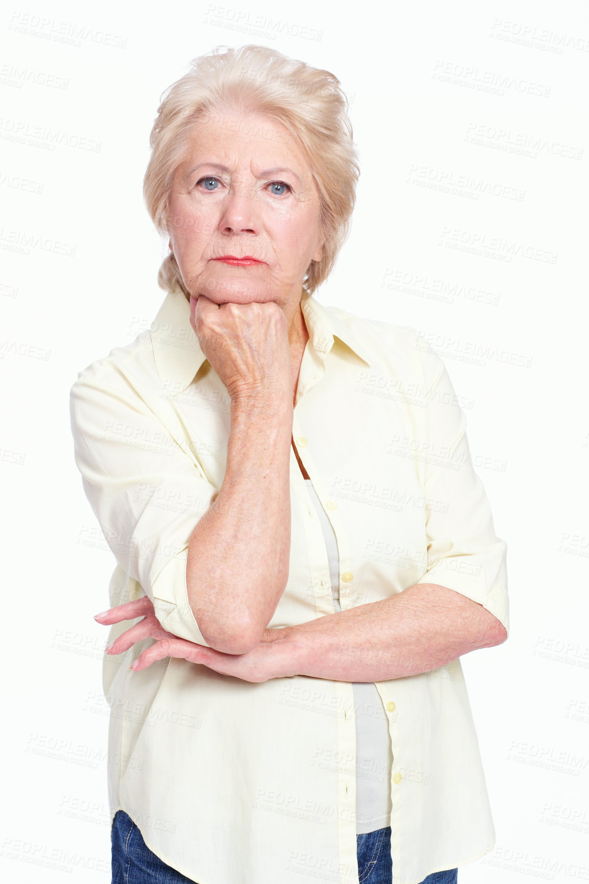 Buy stock photo Portrait of a seething elderly woman resting her fist on her chin while isolated on white