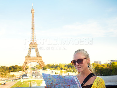 Buy stock photo A pretty young woman holding a map while sight seeing in the Paris