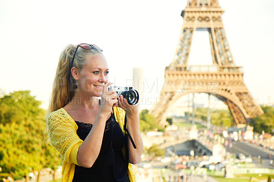 Buy stock photo An attractive young woman holding a camera while sight seeing in the Paris
