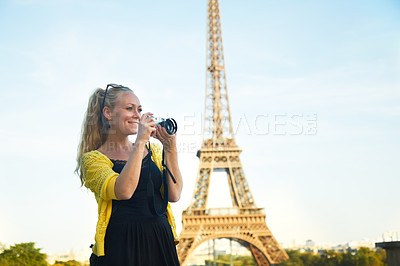 Buy stock photo An attractive young woman taking photos while sight seeing in the Paris