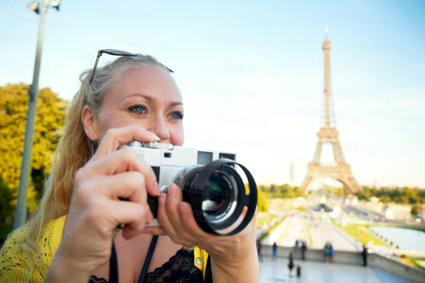Buy stock photo A beautiful young woman holding a camera while sight seeing in the Paris