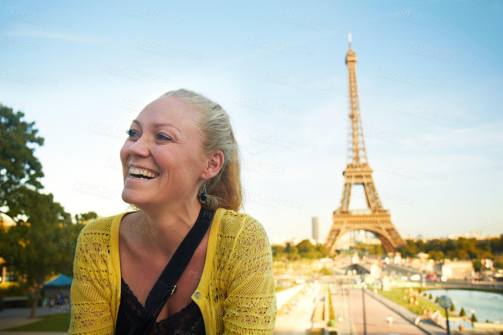 Buy stock photo Woman, laughing and travel to Paris for vacation, happy tourist and sightseeing landmark on trip. Female person, thinking and holiday for reflection in city, urban location and dream of eiffel tower