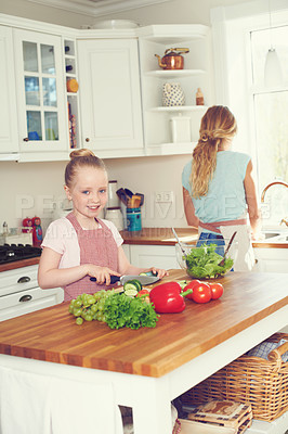 Buy stock photo Portrait, child and cutting vegetables for salad in kitchen with ingredients, meal prep or learning healthy vegan recipe. Mother, girl or cooking together for culinary skills and helping hand in home