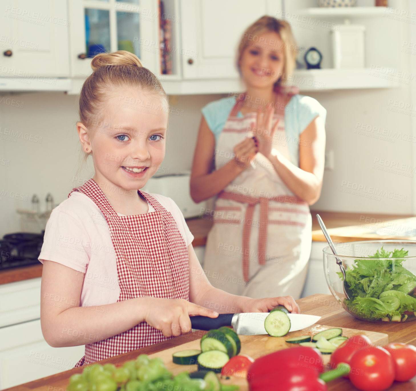 Buy stock photo Portrait, kid and cutting vegetables for salad in kitchen with ingredients, meal prep and learning healthy vegan recipe. Mother, girl and cooking together for culinary skills and helping hand in home