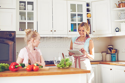 Buy stock photo Salad, child and mom with tablet for cooking, online search and bonding together in home for lunch. Food, mother and daughter in kitchen on digital app for meal prep recipe with healthy vegetables