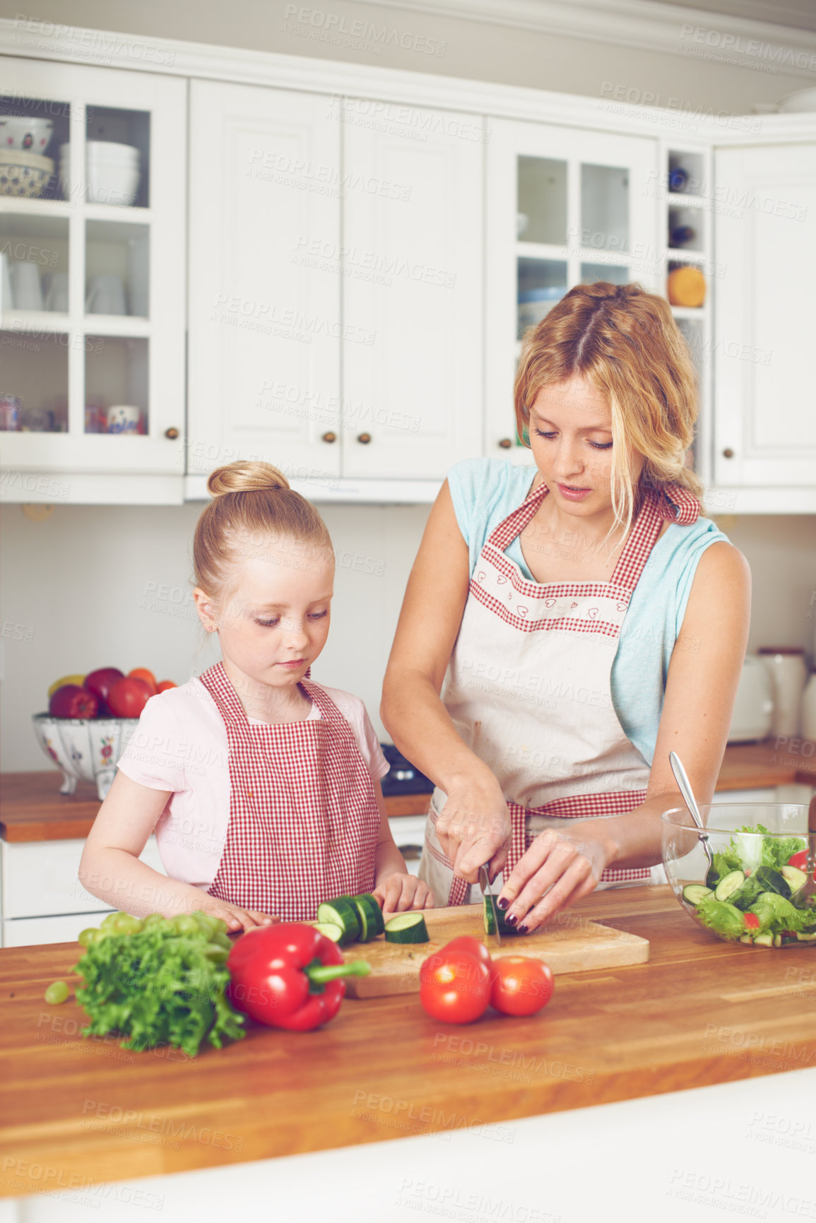 Buy stock photo Mother, child and vegetables for salad in home with cutting ingredients, meal prep and teaching healthy vegan recipe. Woman, girl and learning to cook with support, helping hand or bonding in kitchen