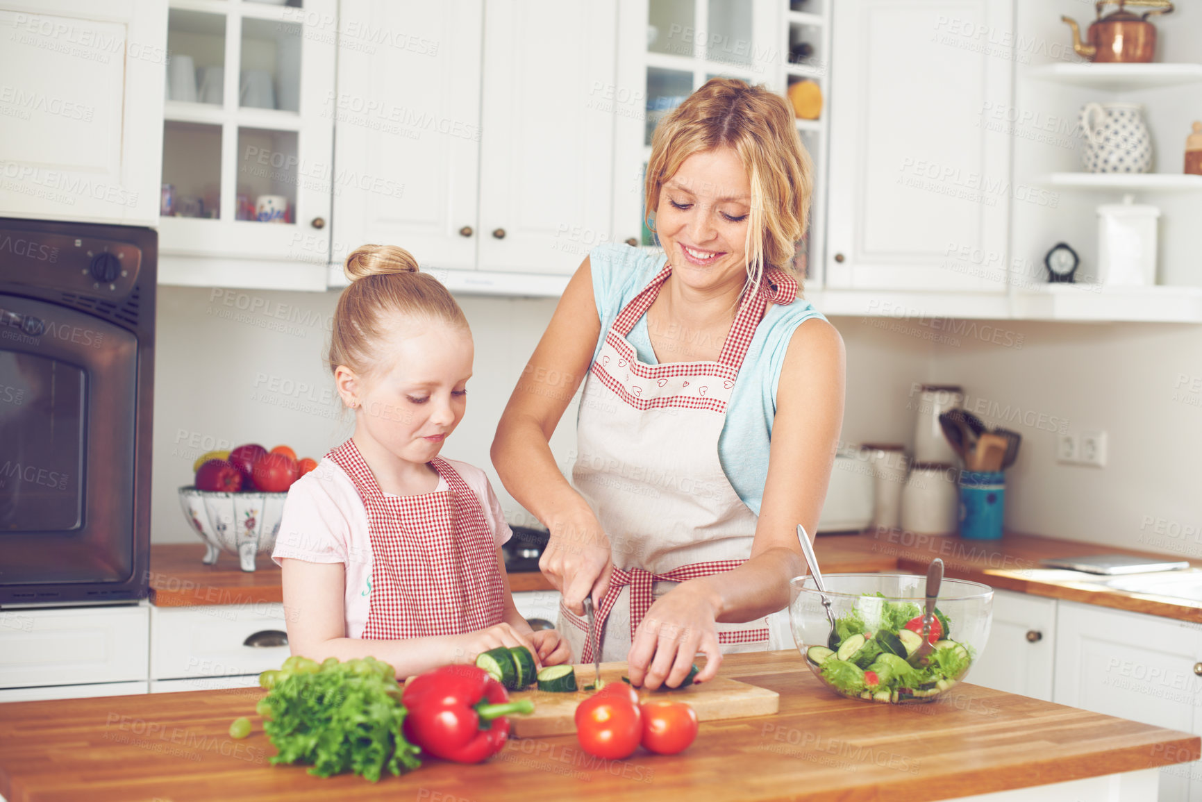 Buy stock photo Mother, kid and preparing a salad in home with cutting ingredients, nutrition meal and teaching healthy vegan recipe. Woman, girl and learning to cook with support, helping hand or bonding in kitchen