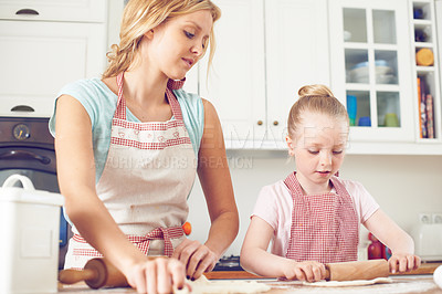 Buy stock photo Mother, girl and rolling pin for dessert in kitchen, dough prep and teaching child skill in home. Mama, daughter and love for help with cookies, cooking wheat and kid learning to bake cake or pastry