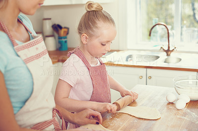 Buy stock photo Mother, girl and rolling pin for pastry in kitchen, preparation and teaching child skills in home. Mommy, daughter and love for helping with cookies, cooking wheat and kid learning to bake cake