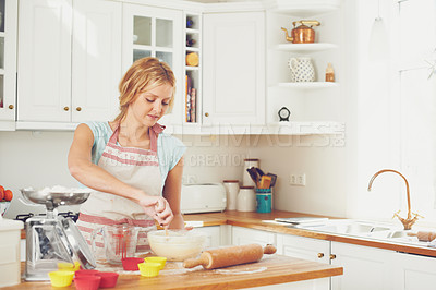 Buy stock photo Woman, mixing and spoon in kitchen for baking, cookies and dessert with cups, bowl and ingredients. Female person, hobby and recipe in home for cooking, cupcakes and food with flour, wheat and skills