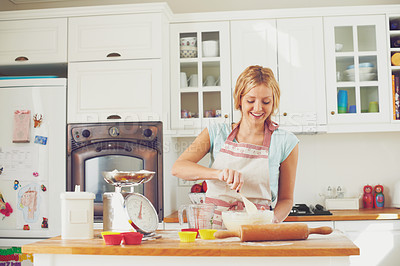 Buy stock photo Woman, happy and spoon in kitchen for baking, cookies and dessert with joy, bowl and ingredients. Female person, smile and recipe in home for cooking, cupcakes and pastry with flour, wheat or skills