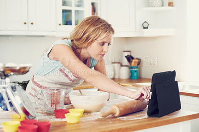 Buy stock photo Woman, tablet and video in kitchen for baking, cookies and online with article, bowl and streaming. Female person, tech and recipe in home for cooking, cupcakes and food with flour, wheat and tips