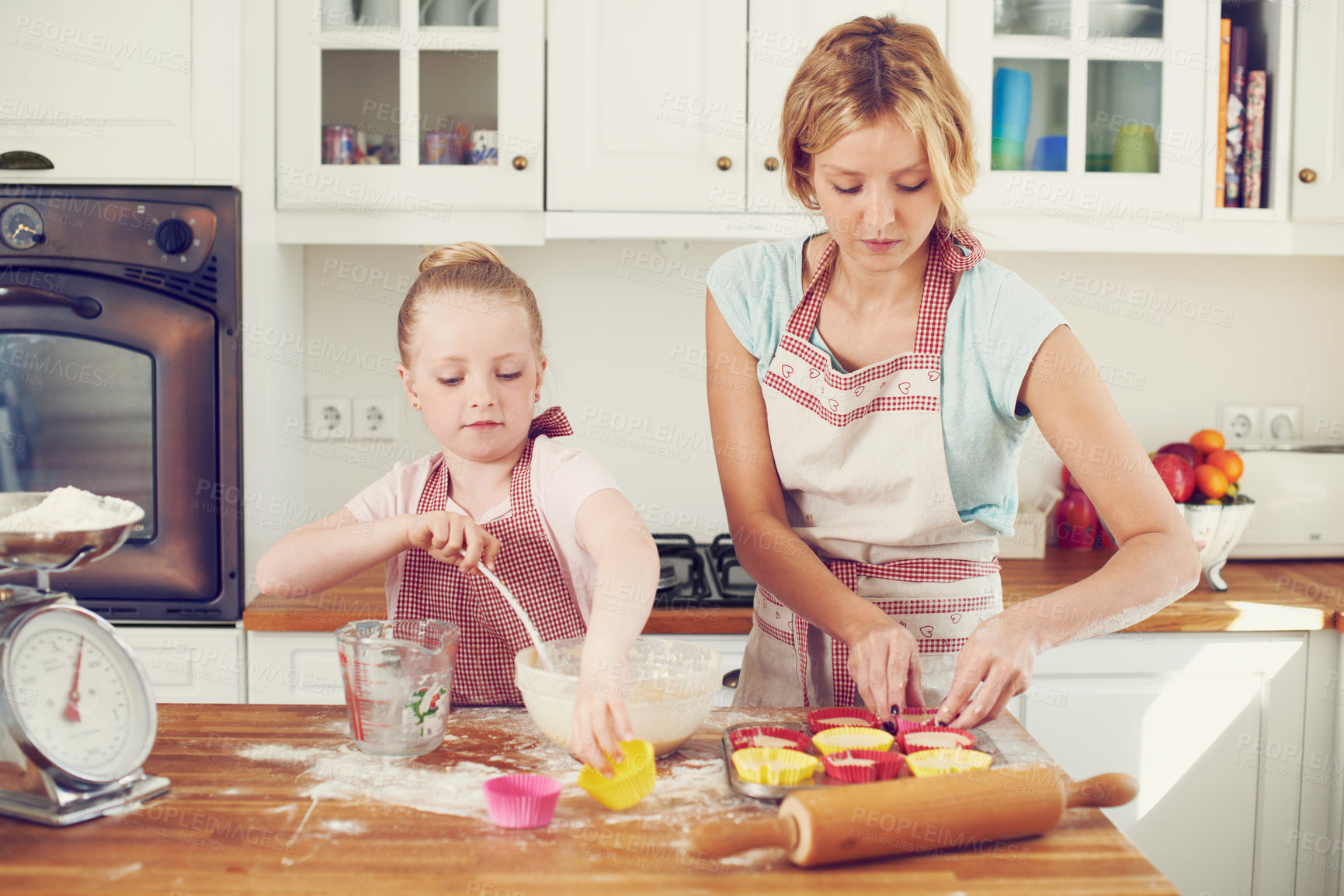 Buy stock photo Kitchen, cupcake and girl helping mother baking with support, learning and morning bonding together. Love, mom and daughter with child development, ingredients and recipe mix in home for kid baker