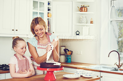 Buy stock photo Frosting, cake and teaching with mother and child in kitchen for baking, ingredients and dessert recipe. Cookie, learning and baker with girl and woman in family home for support, cooking and food