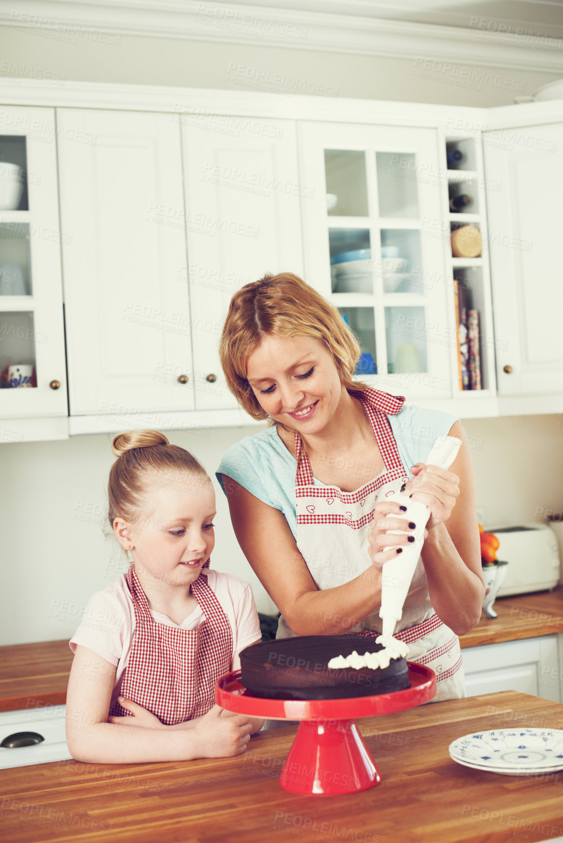 Buy stock photo Frosting, cake and decoration with mother and child in kitchen for baking, ingredients and dessert recipe. Love, learning and baker with girl and woman in family home for support, cooking and food