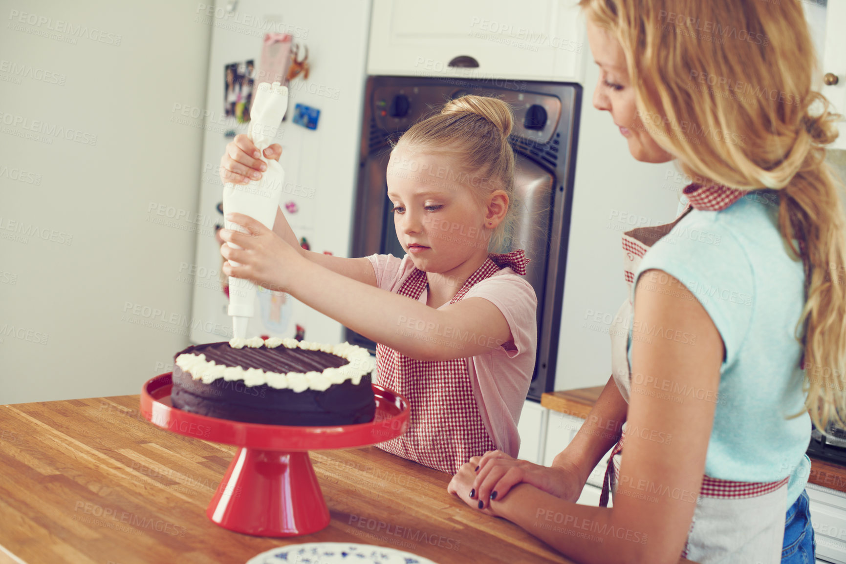 Buy stock photo Frosting, cake and learning with mother and child in kitchen for baking, ingredients and dessert recipe. Love, decoration and baker with girl and woman in family home for support, cooking and food