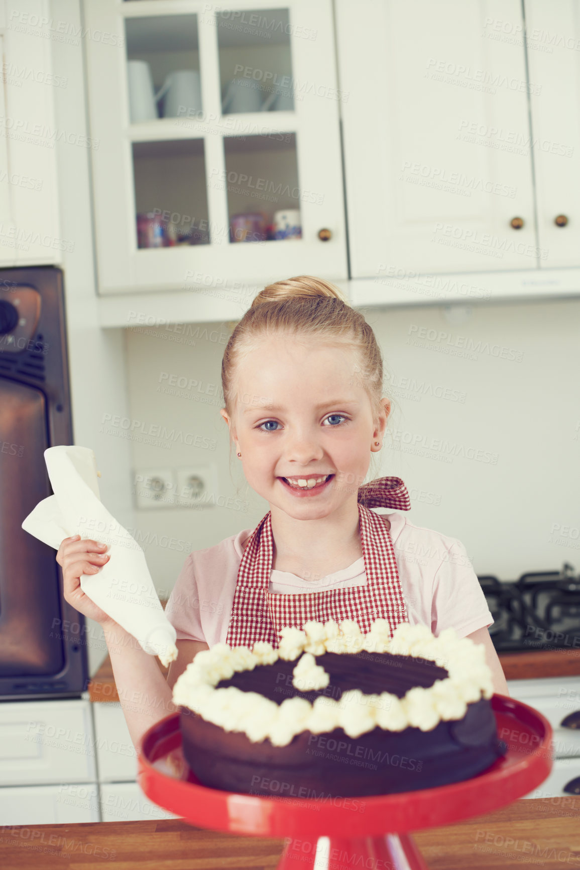 Buy stock photo Child, baking or cake decoration in portrait with cream for dessert recipe, learning or development. Girl, kid baker or piping a buttercream topping for culinary education, preparation or sweet treat