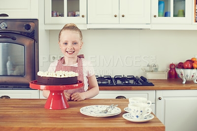 Buy stock photo Girl, child and portrait in kitchen with cake decoration for culinary education, learning recipe and development. Proud kid baker, happy and cooking in home with confidence for sweet snack by counter