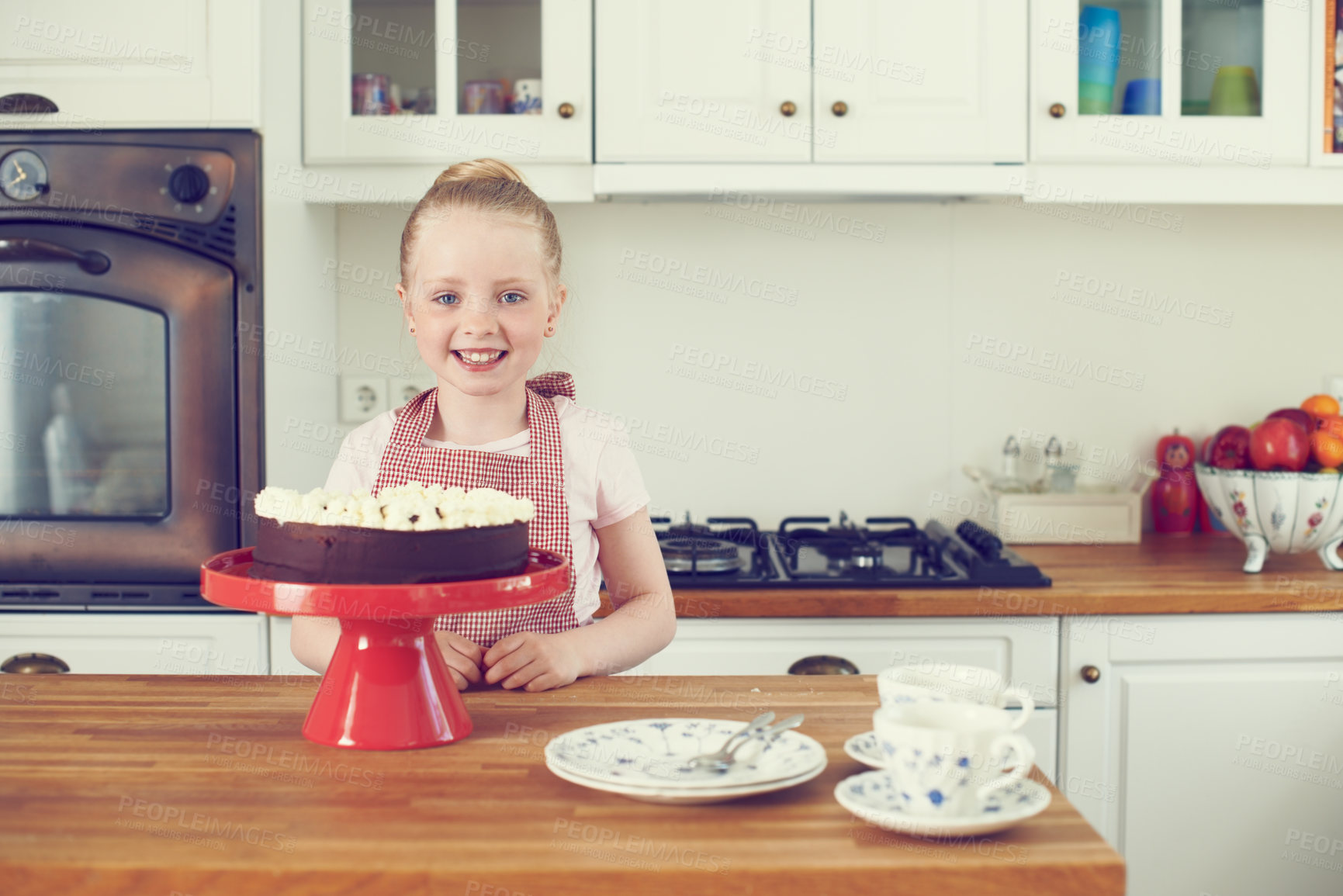 Buy stock photo Girl, child and portrait in kitchen with cake decoration for culinary education, learning recipe and development. Proud kid baker, happy and cooking in home with confidence for sweet snack by counter