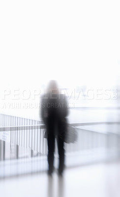 Buy stock photo Blurry person at the airport. Unrecognizable person suffering mental illness, paranoia or aerophobia before traveling. Unknown figure experiencing the effects of a drug addiction against copyspace 