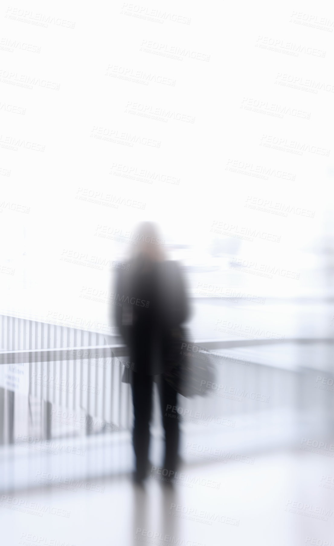 Buy stock photo Blurry person at the airport. Unrecognizable person suffering mental illness, paranoia or aerophobia before traveling. Unknown figure experiencing the effects of a drug addiction against copyspace 