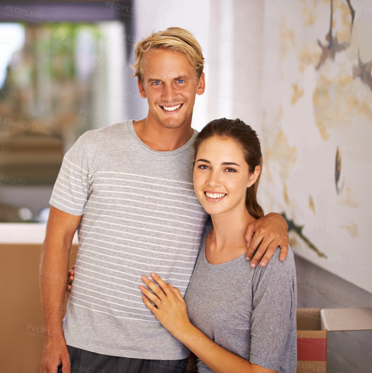 Buy stock photo Happy couple, moving and portrait for Mortgage loan, new home and property investment in hallway of house. Real estate, face of man and woman with hug for apartment, relocation and cardboard box.