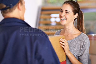 Buy stock photo Shot of a courier making a delivery to a happy customer