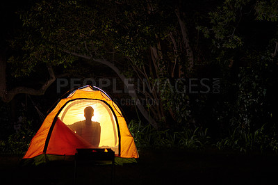 Buy stock photo Cropped shot of the silhouette of a young boy in a tent