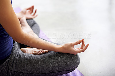 Buy stock photo Cropped shot of a woman practicing yoga at home