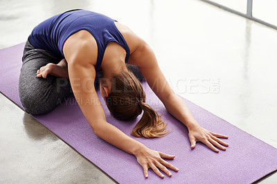 Buy stock photo Full length shot of a sporty woman practicing yoga at home