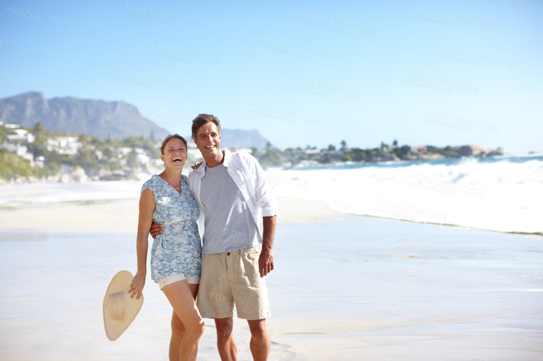 Buy stock photo Travel, couple and happy by ocean with love, summer vacation and excited at sea space. Mature man, woman or holiday on beach resort for anniversary, romantic trip or commitment with wind in Australia