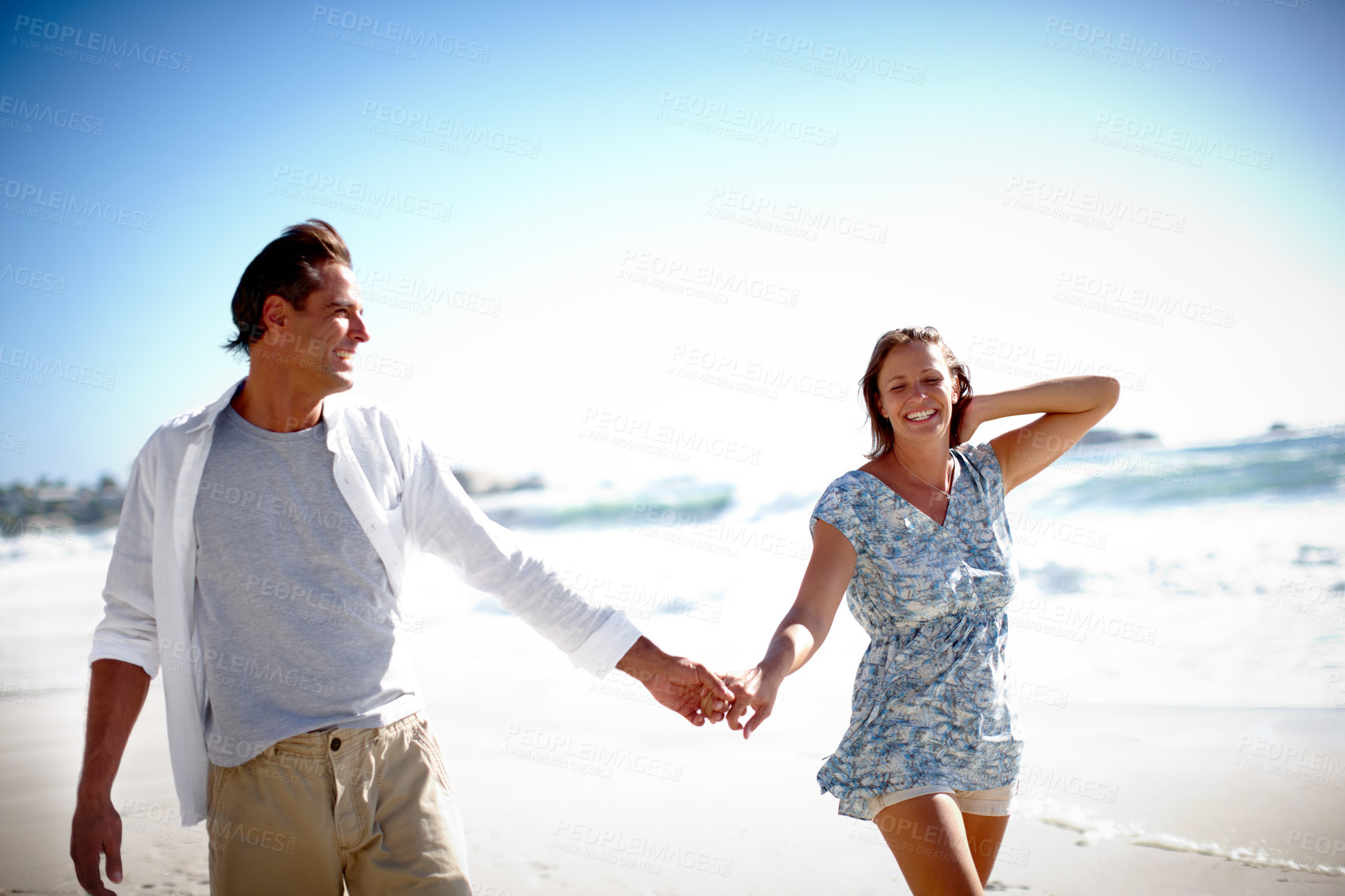 Buy stock photo A happy mature couple taking a relaxing stroll on the beach together